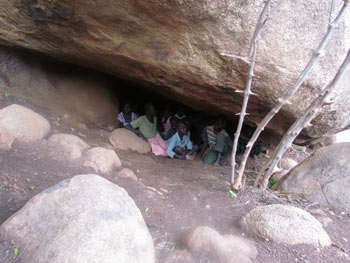 Children hiding under rocks