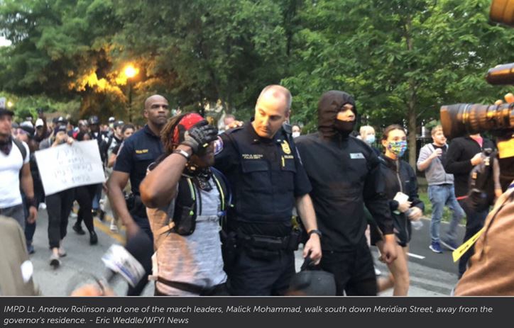 Protest leader and officer walk