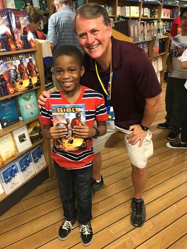 Randy with a child in the bookstore