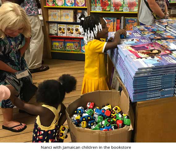 Nanci with Jamaican children in the bookstore