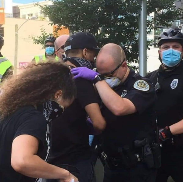 Protester and officer pray